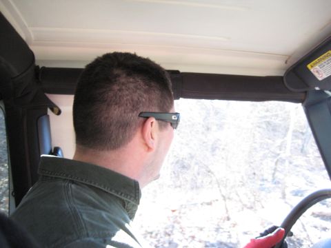 2005 Jeep Wrangler - Driver's perspective inside a 2005 Jeep Wrangler, looking out at a snowy landscape.