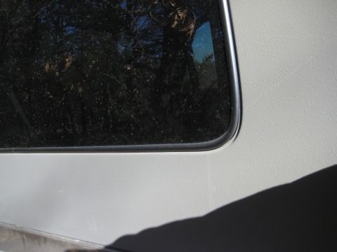 2005 Jeep Wrangler - A close-up of a vehicle's side panel and window frame, with a watermark at the bottom right.