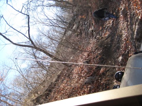 2005 Jeep Wrangler - Interior view of a 2005 Jeep Wrangler on a rocky, wooded hillside.
