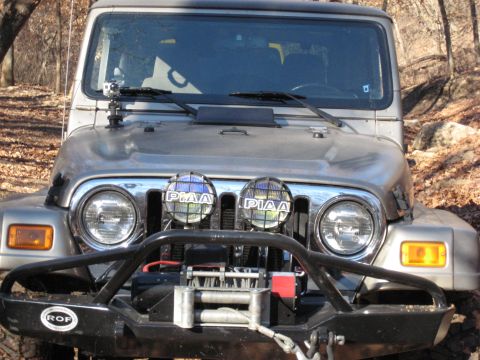 2005 Jeep Wrangler - Front view of a silver 2005 Jeep Wrangler equipped with an aftermarket winch and PIAA driving lights.