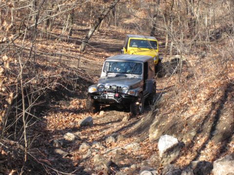 2005 Jeep Wrangler - Two Jeep Wranglers navigate a challenging off-road trail during an autumn excursion.
