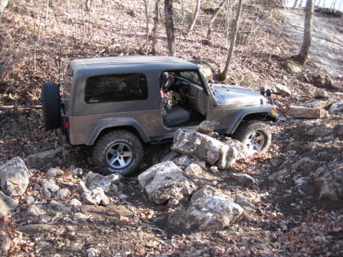 2005 Jeep Wrangler - This 2005 Jeep Wrangler tackles a challenging rocky terrain, demonstrating its off-road capabilities.