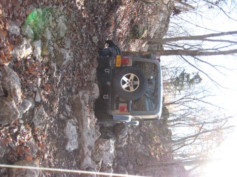 2005 Jeep Wrangler - Jeep Wrangler navigating a challenging rocky trail during the day.