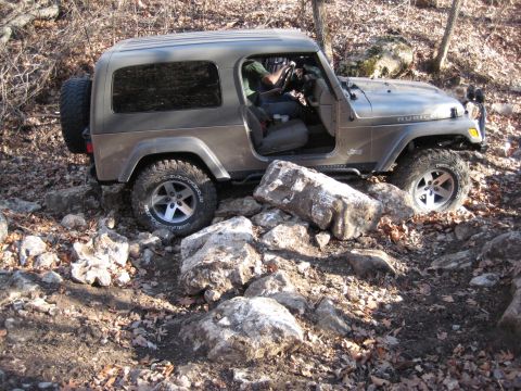 2005 Jeep Wrangler - This Jeep Wrangler Rubicon is shown off-roading over large rocks and uneven ground.
