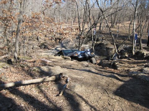 2005 Jeep Wrangler - 2005 Jeep Wrangler tackling a challenging off-road course with steep inclines and large rocks.