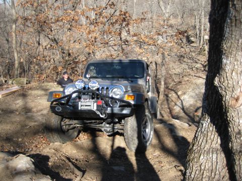 2005 Jeep Wrangler - A Jeep Wrangler tackles a challenging off-road trail on a sunny day.
