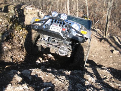 2005 Jeep Wrangler - A Jeep Wrangler navigates a rocky off-road trail, demonstrating its capability on challenging terrain.