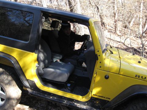 2005 Jeep Wrangler - A yellow Jeep Wrangler, likely a 2007 model or newer, is driven off-road with its doors removed.