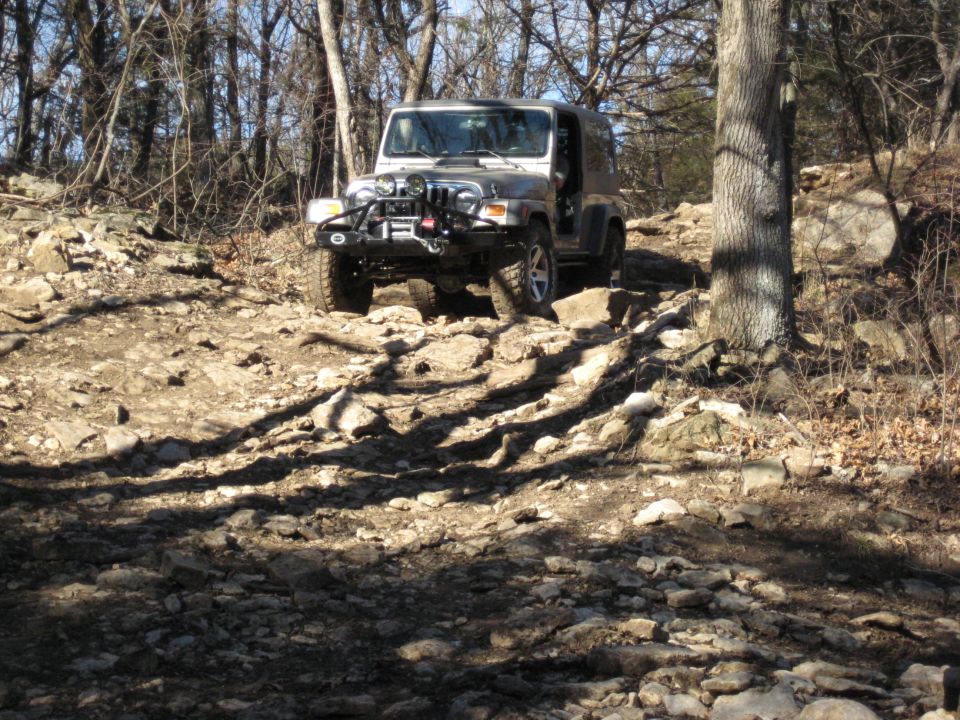Silver 2005 Jeep Wrangler on a rocky trail