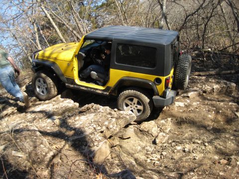 2005 Jeep Wrangler - Yellow 2005 Jeep Wrangler tackling a challenging off-road course.