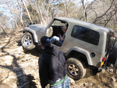 2005 Jeep Wrangler - A silver 2005 Jeep Wrangler tackles a challenging rocky terrain on an off-road adventure.