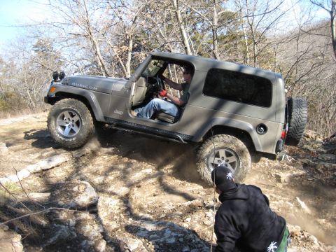 2005 Jeep Wrangler - A gray 2005 Jeep Wrangler Rubicon navigates a challenging rocky terrain during an off-road excursion.