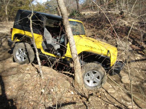 2005 Jeep Wrangler - Yellow 2005 Jeep Wrangler Rubicon off-roading on a rocky trail.