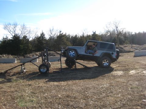 2005 Jeep Wrangler - 2005 Jeep Wrangler positioned on an obstacle course ramp.