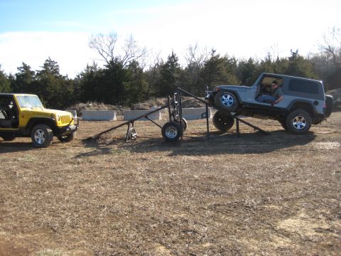 2005 Jeep Wrangler - Two Jeep Wranglers are positioned on an outdoor course with a ramp structure.