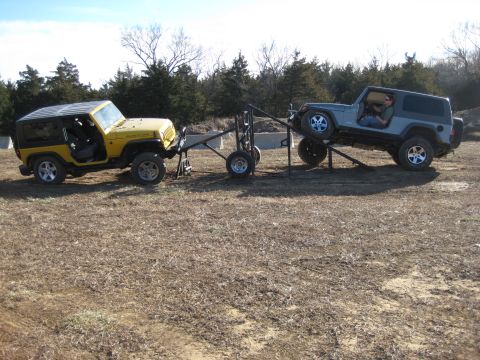 2005 Jeep Wrangler - Two Jeep Wranglers are set up on a trailer, with one being towed by the other.