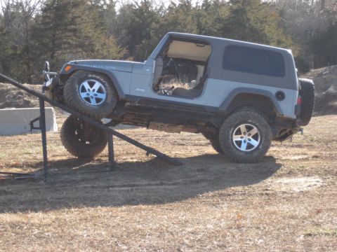 2005 Jeep Wrangler - Jeep Wrangler shown on an off-road obstacle course ramp.
