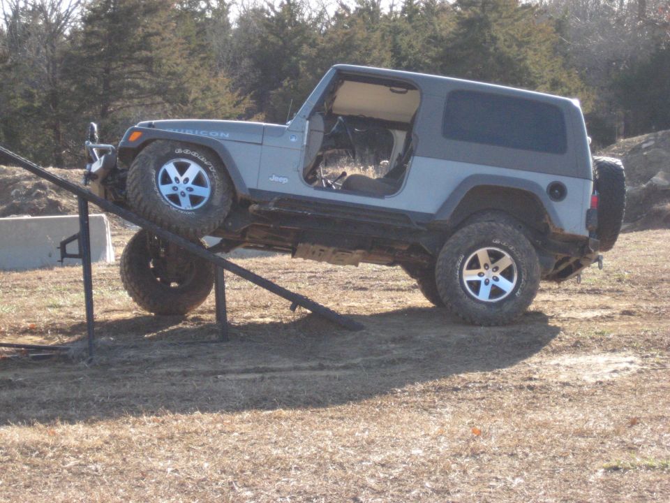 2005 Jeep Wrangler Rubicon with doors removed, climbing a metal ramp