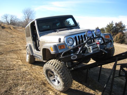 2005 Jeep Wrangler - This silver 2005 Jeep Wrangler Rubicon is positioned on a ramp, equipped with a winch and auxiliary lights.