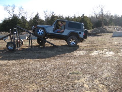 2005 Jeep Wrangler - A Jeep Wrangler is positioned on a ramp, with its front wheels elevated.