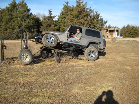 2005 Jeep Wrangler - 2005 Jeep Wrangler positioned on a metal ramp outdoors.