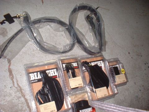 1969 Ford Torino - Various gun holsters and belts are laid out on a concrete surface, with some packaging visible.
