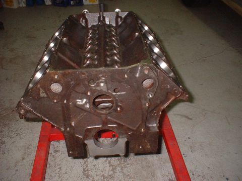 1969 Mercury Cyclone - Engine block on a red stand in a garage setting.