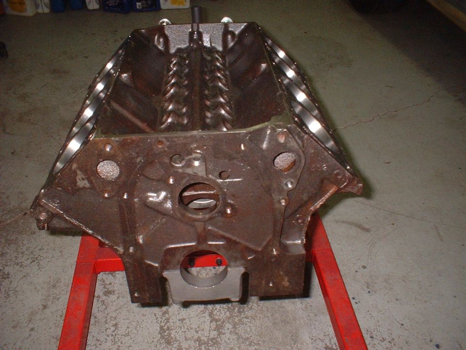 Engine block resting on a red engine stand