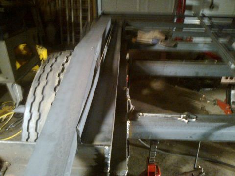 1990 Ford Bronco - The image shows the construction of a trailer frame, with a tire visible in the background. The registry label of 1990 Ford Bronco is not s…