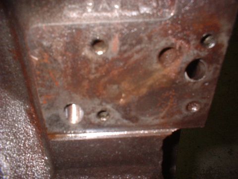 1969 Mercury Cyclone - Close-up of a heavily corroded engine block casting, showing various holes and mounting points.