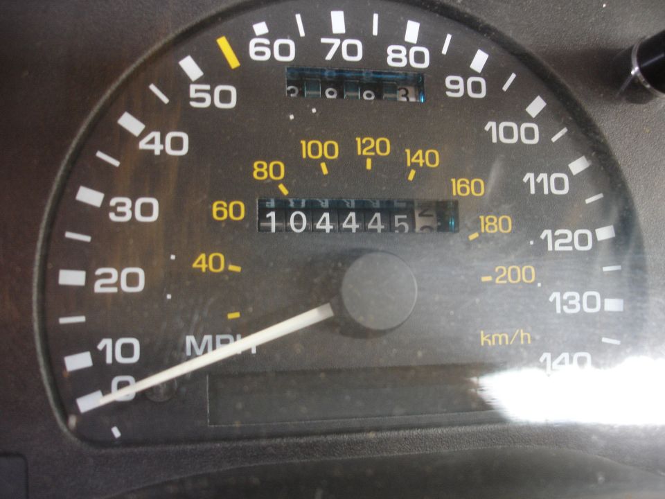 Car odometer showing 104445 miles and speedometer reading 0 MPH
