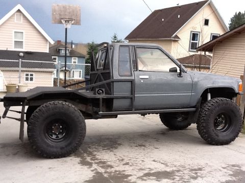 1988 Suzuki Samurai - This heavily modified truck features a flatbed and oversized tires, suggesting off-road capabilities.
