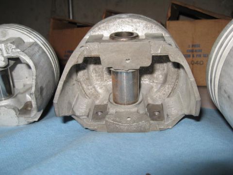 1963 Ford Galaxie - Close-up of engine pistons, with visible markings on the parts and boxes in the background.