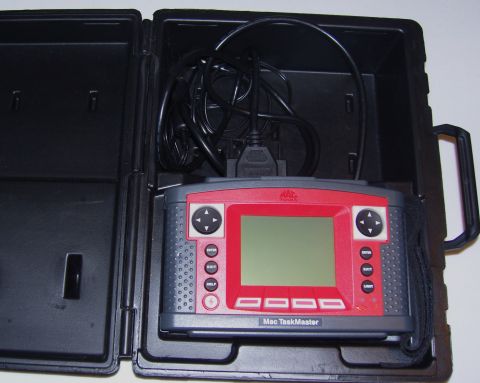 2007 Ford Mustang - Mac TaskMaster diagnostic tool, a part for vehicle repair, shown in its protective black case.
