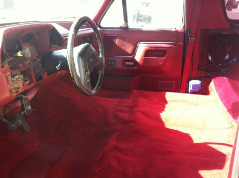 1991 Ford Bronco - Interior view of a 1991 Ford Bronco showing the dashboard and red carpet.