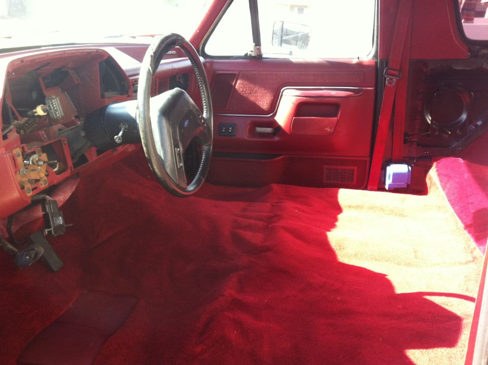 1991 Ford Bronco interior with red carpet and dashboard removed