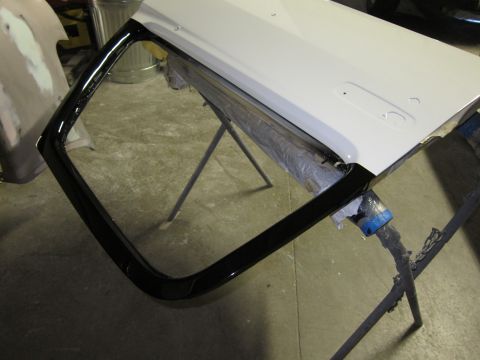 1987 Dodge 1500 - A car door is shown on sawhorses, possibly undergoing repair or painting.