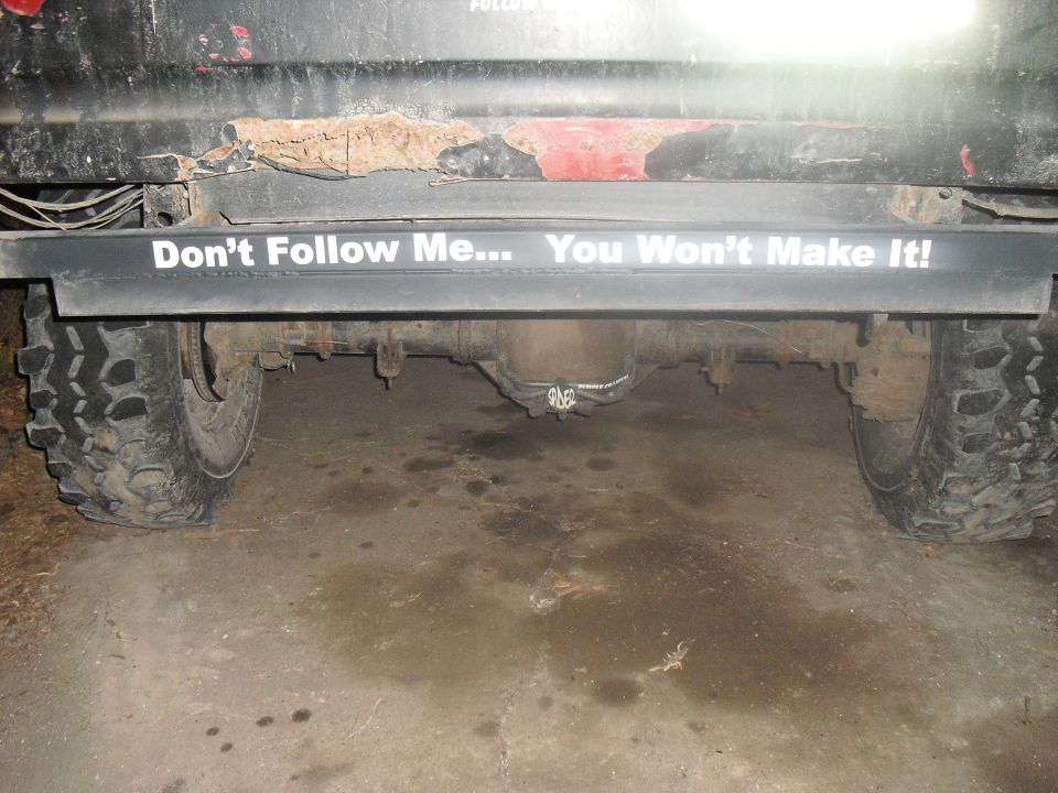 Rear axle and tire of a truck with a "Don't Follow Me... You Won't Make It!" sticker