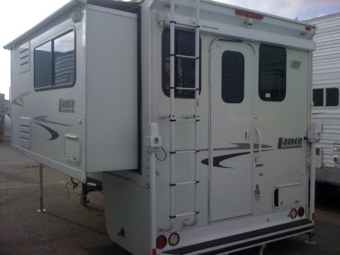 1968 Ford Mustang - This truck camper, branded 'Lance', is shown from the rear, with another camper visible to the right.