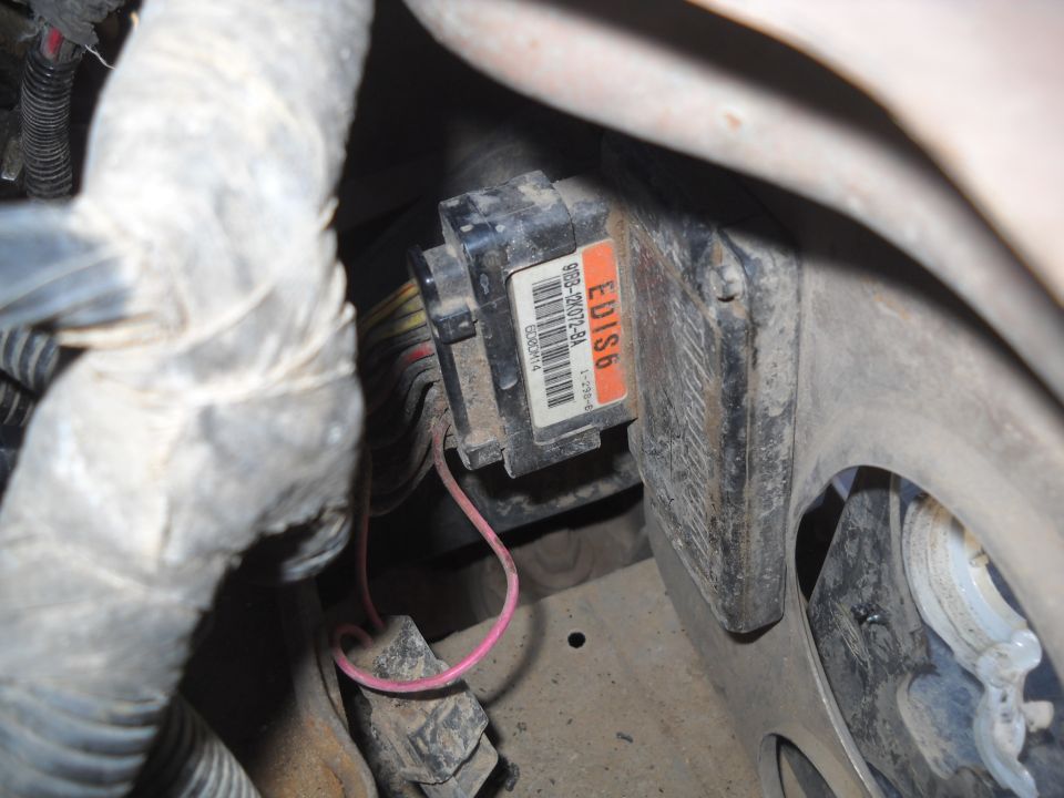 Engine control module with part number F5DB-12A650-BA and red wire