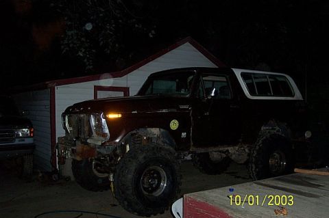 1978 Ford Bronco - This 1978 Ford Bronco is parked outside a building at night, with another vehicle nearby.