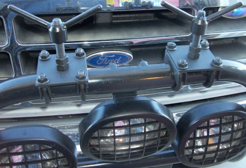 1996 Ford Bronco - Front view of a Ford truck's grille, a light bar with attached auxiliary lights.