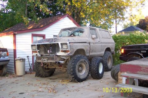 1978 Ford Bronco - This heavily modified Ford Bronco, appearing to be from the late 1970s, is covered in mud and has been fitted with dual rear wheels.