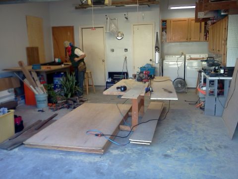 1996 Ford Bronco - A busy garage workshop is set up for a project, with lumber, tools, and appliances visible.
