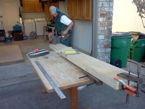 1996 Ford Bronco - A man is working on wood in a garage with tools and lumber visible.