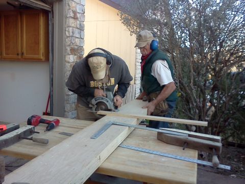 1996 Ford Bronco - Men are working on cutting wood with a circular saw and other tools in an outdoor setting.