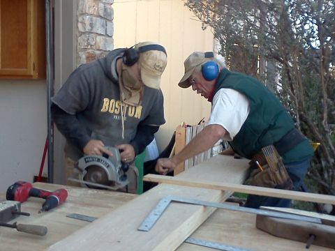 1996 Ford Bronco - Two men are working on a woodworking project outdoors, one using a circular saw.