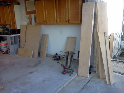 1996 Ford Bronco - A garage scene shows lumber stacked against a wall, with tools including a circular saw and drill on the floor.