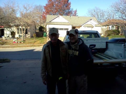 1996 Ford Bronco - Two men pose for a photo in front of a pickup truck loaded with lumber, with a black car in the background.