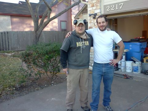 1996 Ford Bronco - Two men pose for a photo in front of a residential garage, with the house number 2217 clearly displayed.